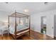 Spacious bedroom featuring a four-poster bed and hardwood flooring at 1626 Beverly Dr, Charlotte, NC 28207