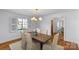 Traditional dining room with a wood table, elegant chairs, and natural light at 1626 Beverly Dr, Charlotte, NC 28207