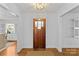 Warm and inviting foyer with a wood door, light-colored walls, and hardwood floors at 1626 Beverly Dr, Charlotte, NC 28207