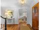 Bright foyer with hardwood floors and a view into the dining room; lovely light fixture at 1626 Beverly Dr, Charlotte, NC 28207