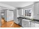 Kitchen featuring custom cabinets, a stainless steel dishwasher and a farmhouse sink at 1626 Beverly Dr, Charlotte, NC 28207