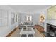 Bright living room featuring a fireplace, neutral-toned furniture, and plenty of natural light at 1626 Beverly Dr, Charlotte, NC 28207