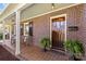 Inviting covered porch with rocking chairs and beautiful brickwork details on the exterior at 1626 Beverly Dr, Charlotte, NC 28207