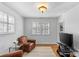 Cozy sitting room with hardwood floors, comfortable armchairs, and natural light from window at 1626 Beverly Dr, Charlotte, NC 28207