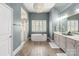 Bright bathroom with a modern soaking tub, glass-enclosed shower, and dual vanity sinks at 2007 Fernhurst Ter, Matthews, NC 28104