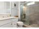 Modern bathroom with glass shower, vanity with marble countertop, and updated fixtures at 2007 Fernhurst Ter, Matthews, NC 28104
