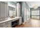 Elegant bathroom showcasing custom cabinetry, a vanity area, and a soaking tub beneath a window at 2007 Fernhurst Ter, Matthews, NC 28104