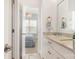 Hallway bathroom featuring double sinks, custom cabinets and a view into the bedroom at 2007 Fernhurst Ter, Matthews, NC 28104