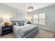Serene bedroom with a plush bed, nautical decor, and soft natural light from the window at 2007 Fernhurst Ter, Matthews, NC 28104