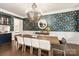 Elegant dining room with stylish wallpaper, chandelier, and a view to a serving bar at 2007 Fernhurst Ter, Matthews, NC 28104