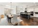 Open concept kitchen featuring an island, modern lighting, and stainless steel appliances at 2007 Fernhurst Ter, Matthews, NC 28104