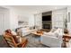 Bright living room featuring a stone fireplace, shiplap accents, and large windows with great lighting at 2007 Fernhurst Ter, Matthews, NC 28104