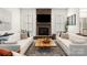 Spacious living room with stone fireplace and large windows offering lots of natural light at 2007 Fernhurst Ter, Matthews, NC 28104