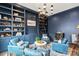 Well-appointed study with custom built-in shelving, a chandelier and comfortable seating at 2007 Fernhurst Ter, Matthews, NC 28104