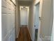 Hallway with wood-look floors, with multiple closets, leading to other rooms in the home at 2190 Pacer Rd, Lancaster, SC 29720