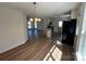 Open-concept kitchen featuring stainless steel appliances, a granite countertop island, and wood-look flooring at 2190 Pacer Rd, Lancaster, SC 29720