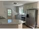 Bright kitchen featuring granite counters, stainless steel appliances and fixtures, white cabinets, and a view to the backyard at 2190 Pacer Rd, Lancaster, SC 29720