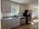 Spacious kitchen featuring granite countertops, stainless steel refrigerator, and white cabinets with black hardware at 2190 Pacer Rd, Lancaster, SC 29720