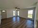 Bright living room featuring wood-look flooring, a ceiling fan, and multiple windows providing plenty of natural light at 2190 Pacer Rd, Lancaster, SC 29720