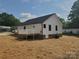 Home exterior featuring a deck, dark roof and white vinyl siding at 2200 Clay St # 2, Kannapolis, NC 28083