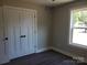 Well-lit bedroom with hardwood floors, a window view, and a closet at 2200 Clay St # 2, Kannapolis, NC 28083