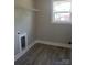 Well-lit laundry room with window, modern gray tile flooring, and white trim at 2200 Clay St # 2, Kannapolis, NC 28083