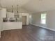 Bright living room with an open floor plan into the modern kitchen and light gray walls at 2200 Clay St # 2, Kannapolis, NC 28083