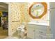 Bathroom with floral wallpaper, white vanity, and accessible toilet at 2455 Wellridge Rd, Chester, SC 29706