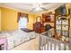 Bright bedroom featuring yellow walls, ceiling fan, and cozy sleeping arrangements at 2455 Wellridge Rd, Chester, SC 29706