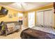 Bedroom with yellow walls, ceiling fan, and bed with decorative bedding at 2455 Wellridge Rd, Chester, SC 29706