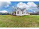 Exterior view of a quaint single story home with white siding and a spacious lawn at 2455 Wellridge Rd, Chester, SC 29706