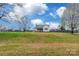 Charming exterior view of a quaint single story home on a sprawling green lot under a bright blue sky at 2455 Wellridge Rd, Chester, SC 29706