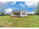 View of the home with white siding, a cozy front porch with seating and red shutters at 2455 Wellridge Rd, Chester, SC 29706