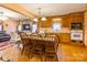 Open concept kitchen with stone fireplace, island and wooden cabinetry at 2455 Wellridge Rd, Chester, SC 29706