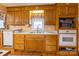 Traditional kitchen with wooden cabinets, laminate countertops, and stainless steel microwave and oven at 2455 Wellridge Rd, Chester, SC 29706
