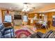 An open-concept home featuring a stone fireplace, hardwood floors, and seamless transition into kitchen at 2455 Wellridge Rd, Chester, SC 29706