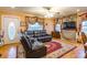 View of the living room featuring a comfortable leather sectional, hardwood floors, and natural light at 2455 Wellridge Rd, Chester, SC 29706