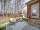 A charming back patio space with chairs and a small table offers a serene outdoor escape at 2538 Cherry Bark Oak Ct, Gastonia, NC 28056