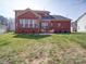 A brick home featuring a large backyard and outdoor patio seating area at 2538 Cherry Bark Oak Ct, Gastonia, NC 28056