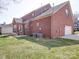 Brick home featuring a well-maintained backyard and outdoor patio seating area at 2538 Cherry Bark Oak Ct, Gastonia, NC 28056