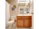 Bathroom with brown vanity and drawers, toilet, shower curtain, and wall art at 2538 Cherry Bark Oak Ct, Gastonia, NC 28056