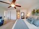 Inviting primary bedroom with a ceiling fan, wall mirror, ensuite bath, and sitting chair at 2538 Cherry Bark Oak Ct, Gastonia, NC 28056