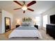 Comfortable primary bedroom with ceiling fan, bedside tables, large bed and a wall mirror at 2538 Cherry Bark Oak Ct, Gastonia, NC 28056