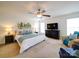 Bright primary bedroom with ceiling fan, sitting area, large bed and artwork at 2538 Cherry Bark Oak Ct, Gastonia, NC 28056