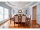 Elegant dining room with tray ceiling, hardwood floors, and ample natural light, ideal for gatherings at 2538 Cherry Bark Oak Ct, Gastonia, NC 28056