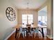 Bright dining room with hardwood floors, modern light fixture, and large window at 2538 Cherry Bark Oak Ct, Gastonia, NC 28056