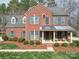 Charming brick home showcasing a covered porch, manicured landscaping, and inviting curb appeal at 2538 Cherry Bark Oak Ct, Gastonia, NC 28056