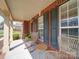 Inviting front porch with cozy seating, offering a perfect spot to relax and enjoy the outdoors at 2538 Cherry Bark Oak Ct, Gastonia, NC 28056