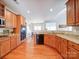 Spacious kitchen featuring granite countertops, stainless steel appliances, and warm wood cabinetry at 2538 Cherry Bark Oak Ct, Gastonia, NC 28056