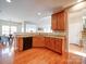Open kitchen featuring granite countertops, wooden cabinets, and stainless steel dishwasher at 2538 Cherry Bark Oak Ct, Gastonia, NC 28056
